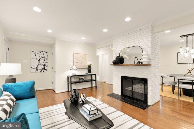 a view of a room with furniture and wooden floor