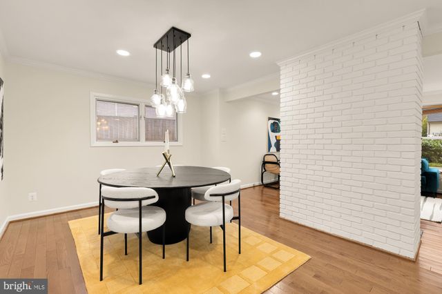 a kitchen with stainless steel appliances granite countertop a stove a refrigerator a sink a microwave and with a dining table