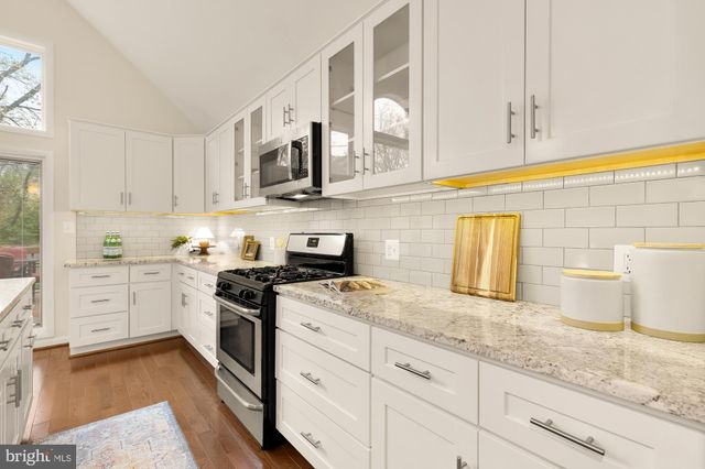 a living room with furniture a mirror and a large window