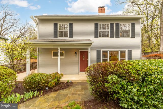 a view of a balcony with flower plants