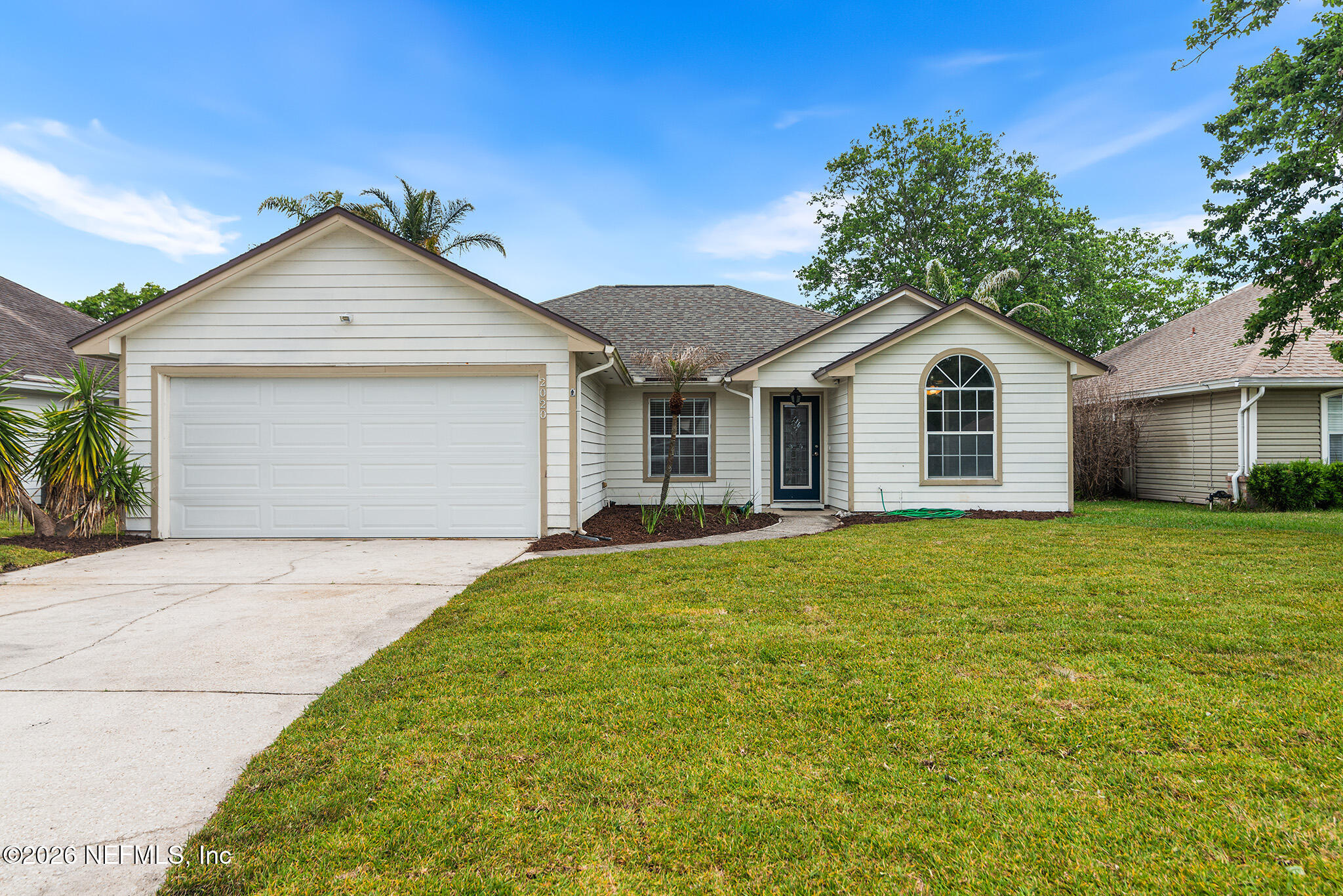 2020 Merced Court Jacksonville, FL 32224 - Photo 2 of 29 a view of a yard in front of a house with a garden