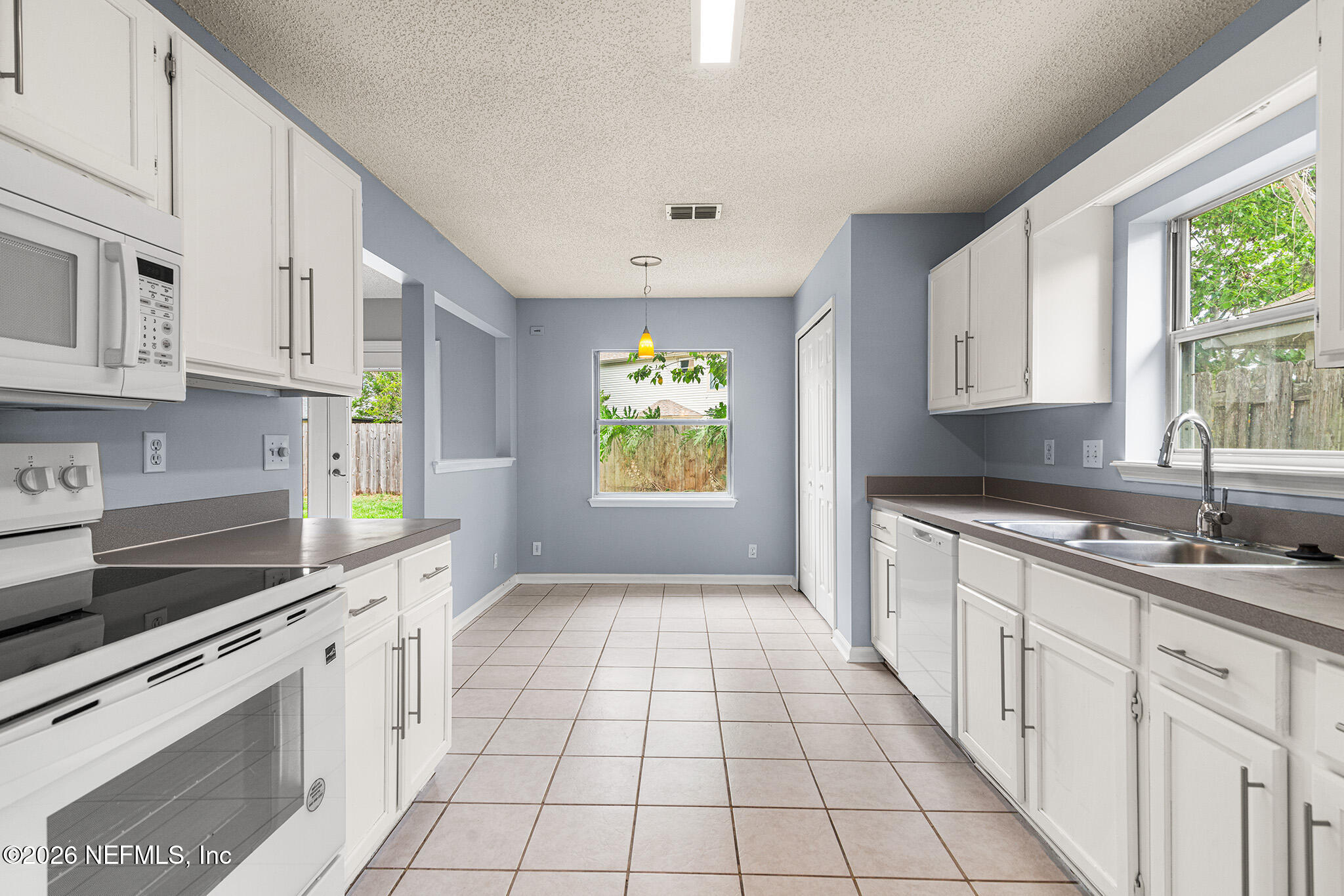 2020 Merced Court Jacksonville, FL 32224 - Photo 8 of 29 a kitchen with stainless steel appliances granite countertop a stove a sink and white cabinets