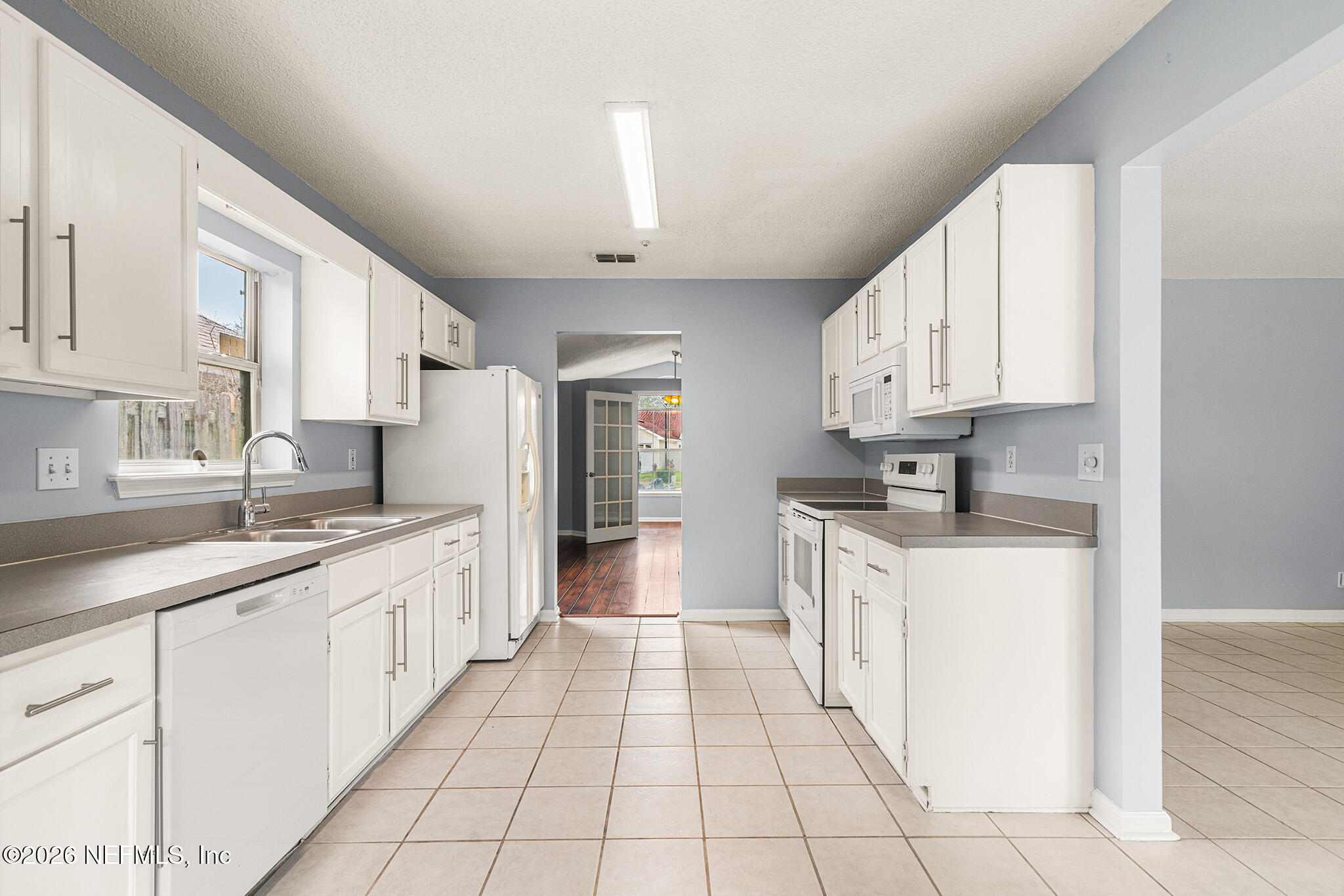 2020 Merced Court Jacksonville, FL 32224 - Photo 9 of 29 a kitchen with granite countertop white cabinets and white appliances