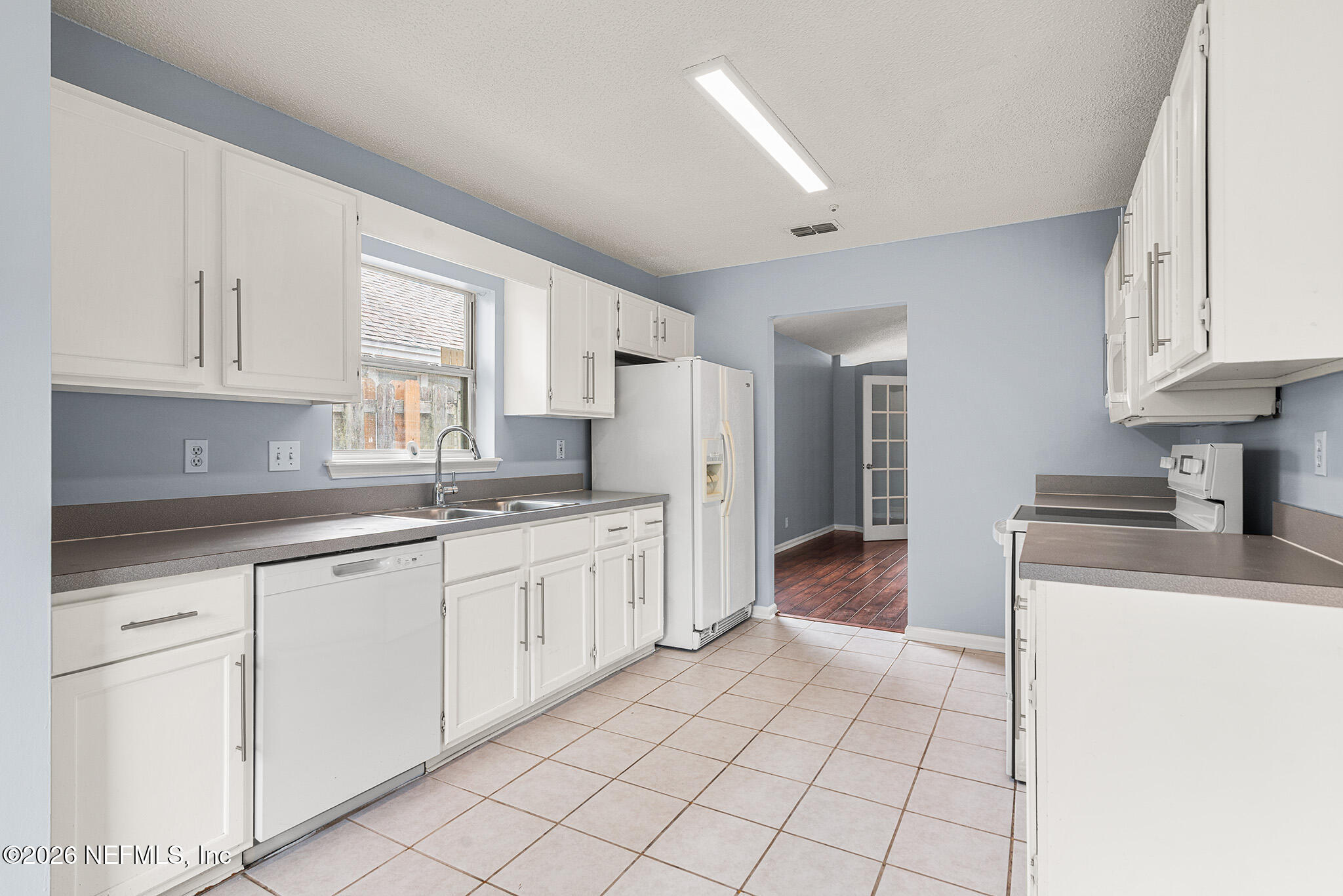 2020 Merced Court Jacksonville, FL 32224 - Photo 10 of 29 a kitchen with granite countertop white cabinets and white appliances