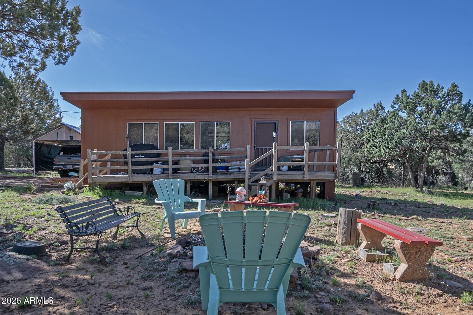 a view of house with backyard outdoor seating and green space