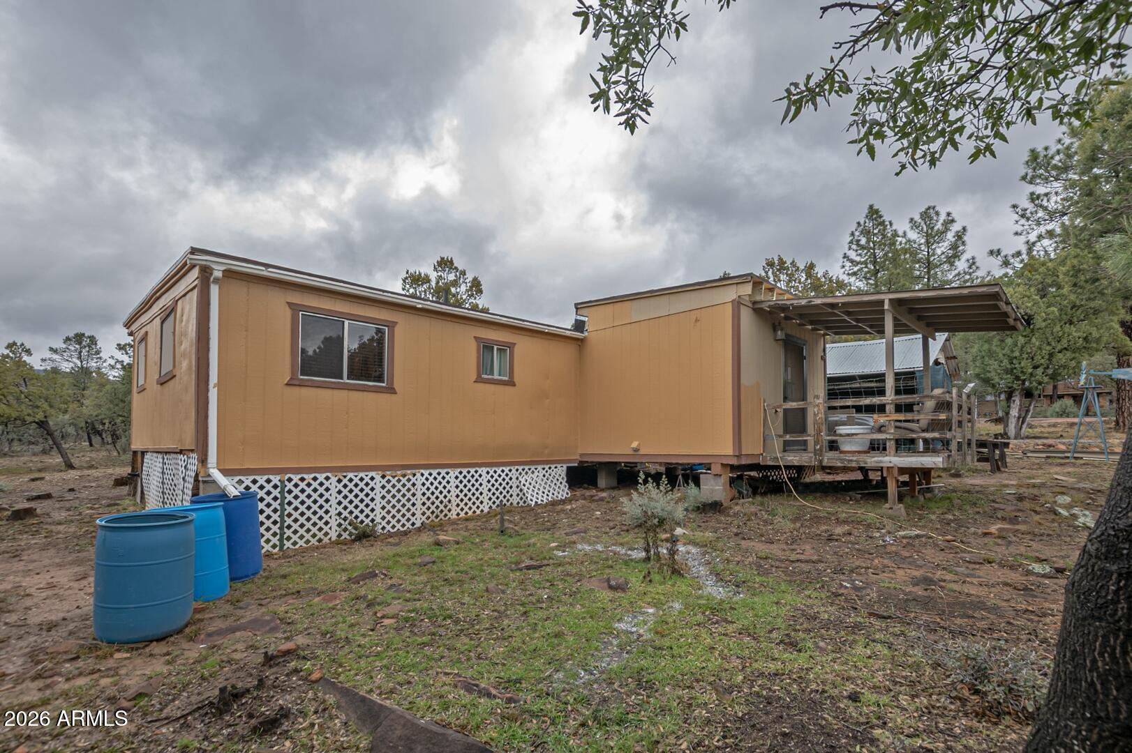 4120 North Whispering Pine Road Pine, AZ 85544 - Photo 17 of 30 a backyard of a house with table and chairs