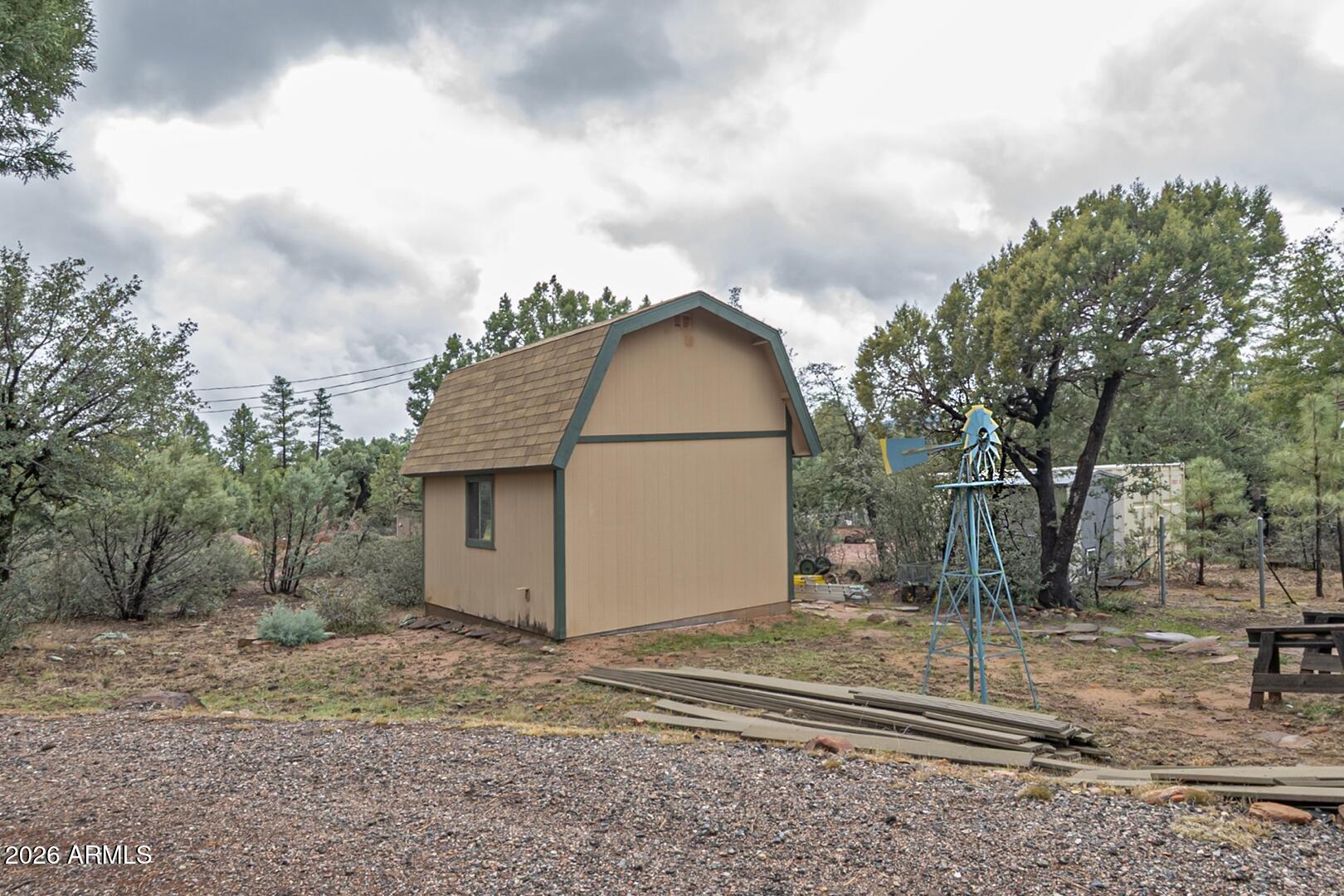 4120 North Whispering Pine Road Pine, AZ 85544 - Photo 21 of 30 a view of a barn in the middle of a yard