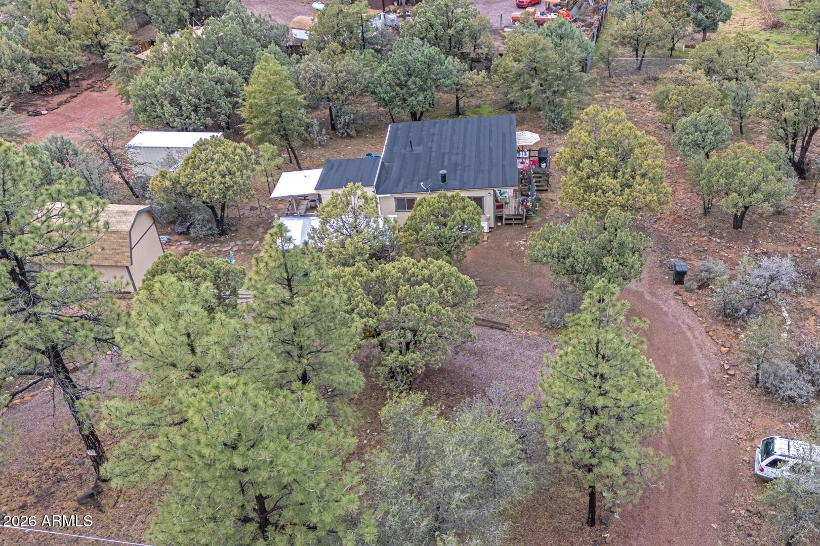 4120 North Whispering Pine Road Pine, AZ 85544 - Photo 30 of 30 an aerial view of a house with a yard and trees all around