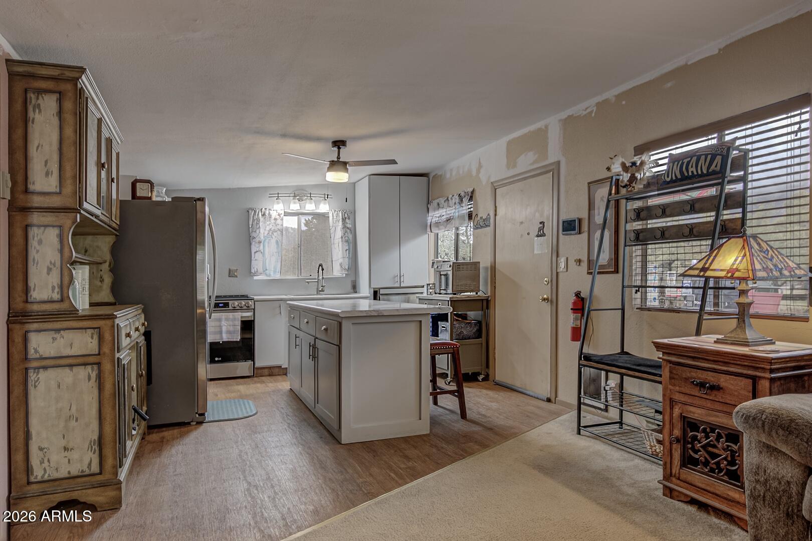 4120 North Whispering Pine Road Pine, AZ 85544 - Photo 4 of 30 a kitchen with refrigerator and cabinets