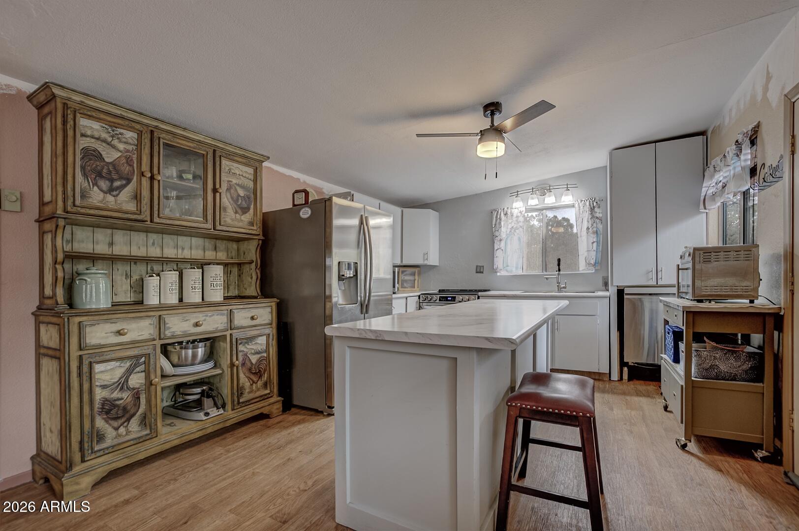 4120 North Whispering Pine Road Pine, AZ 85544 - Photo 5 of 30 a kitchen with appliances cabinets and a counter top space