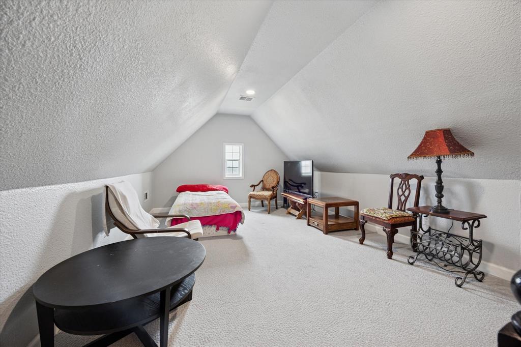 119 George Owens Road Ponder, TX 76259 - Photo 16 of 26 Carpeted room featuring a vaulted ceiling and a single pane window