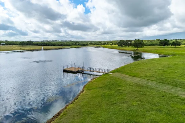 a view of a lake with houses in the back
