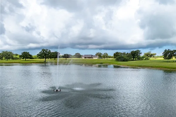 a view of a lake with houses in the background
