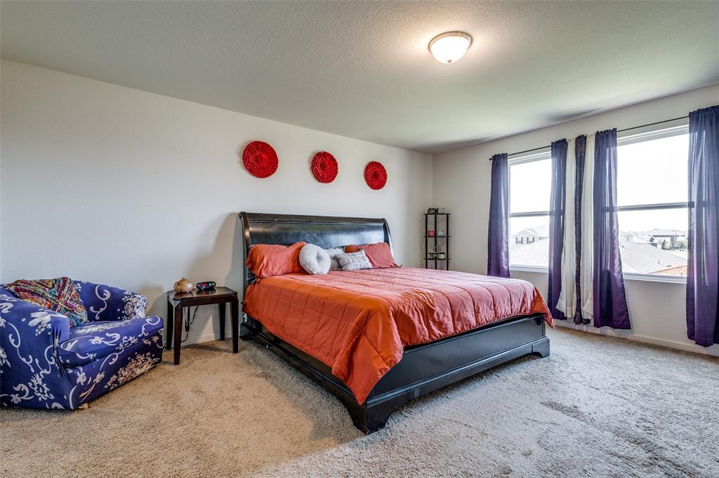 5525 McMahan Lane Fort Worth, TX 76036 - Photo 11 of 21 a bedroom with a bed and cabinets