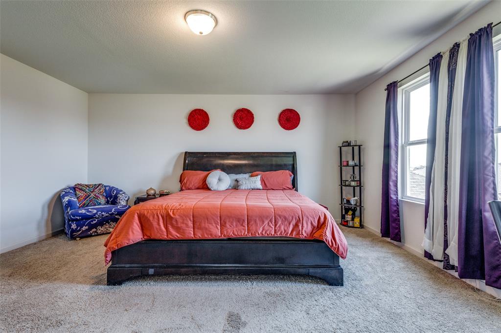 5525 McMahan Lane Fort Worth, TX 76036 - Photo 12 of 21 a spacious bedroom with a bed and a window