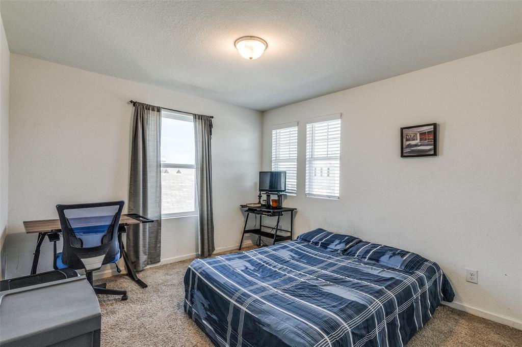 5525 McMahan Lane Fort Worth, TX 76036 - Photo 15 of 21 a bed sitting in a bedroom next to a window