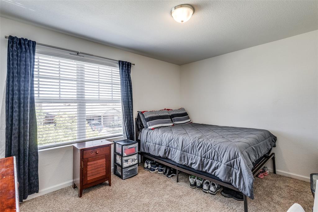 5525 McMahan Lane Fort Worth, TX 76036 - Photo 18 of 21 a bedroom with a bed and a window