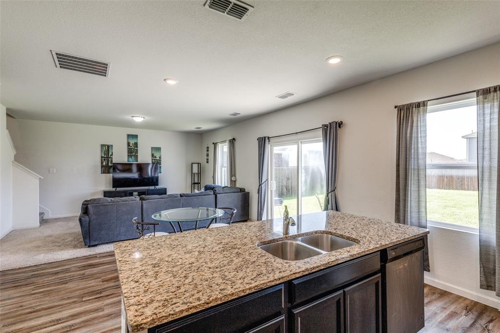 5525 McMahan Lane Fort Worth, TX 76036 - Photo 3 of 21 a kitchen with granite countertop sink and stove