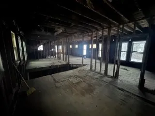 a view of water heater room with a car parked