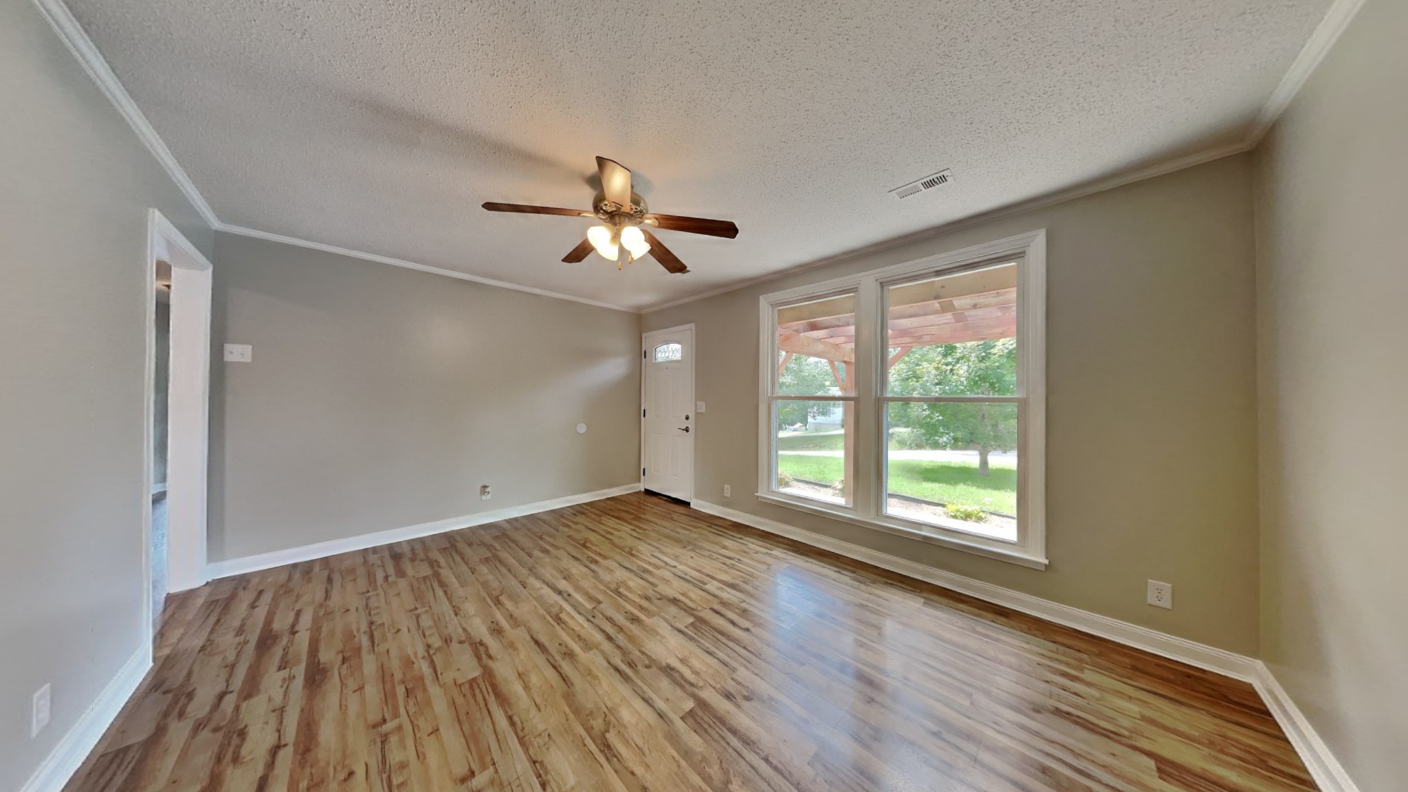 1307 Old Gratton Road Clarksville, TN 37043 - Photo 2 of 10 a view of an empty room with a window and wooden floor