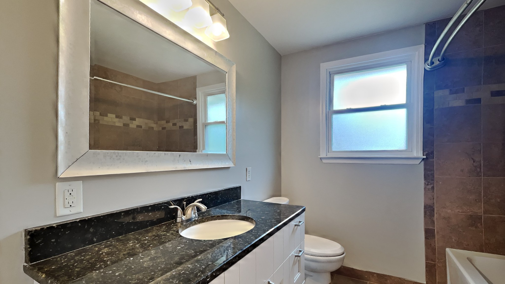 1307 Old Gratton Road Clarksville, TN 37043 - Photo 6 of 10 a bathroom with a granite countertop sink a toilet a mirror and window