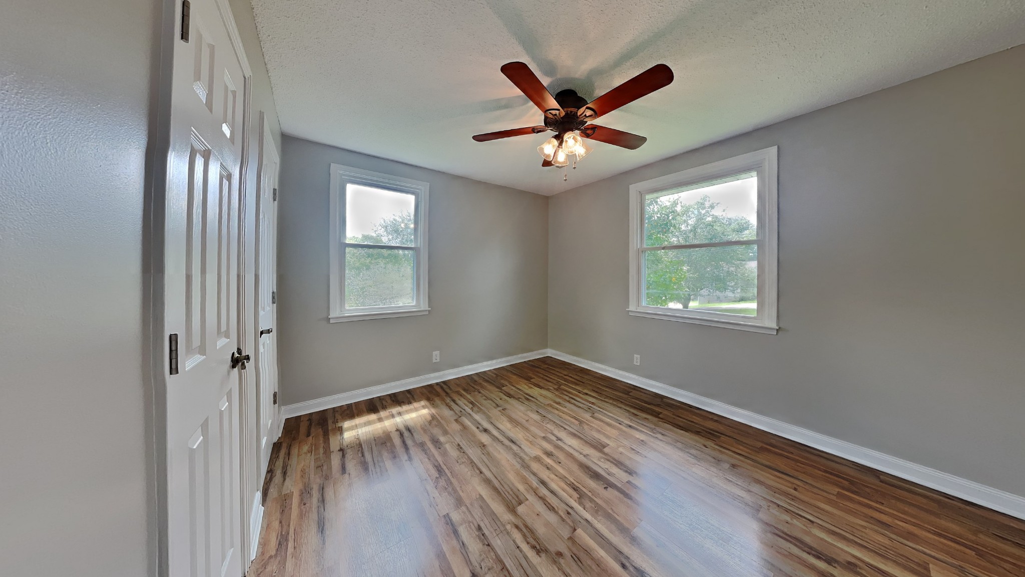 1307 Old Gratton Road Clarksville, TN 37043 - Photo 7 of 10 a view of empty room with wooden floor and fan