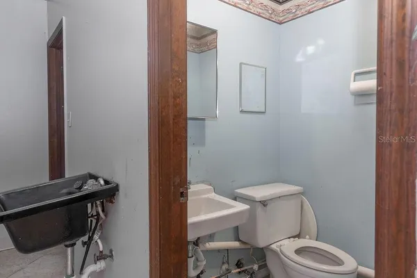 a white toilet sitting next to a bathroom sink