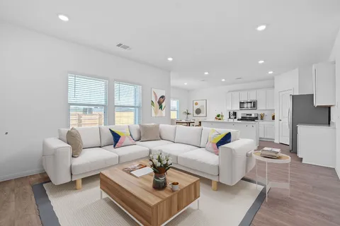 a living room with furniture and a large window