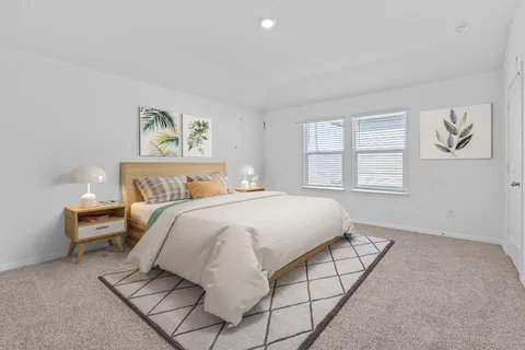 a bedroom with a bed and a painting on the wall