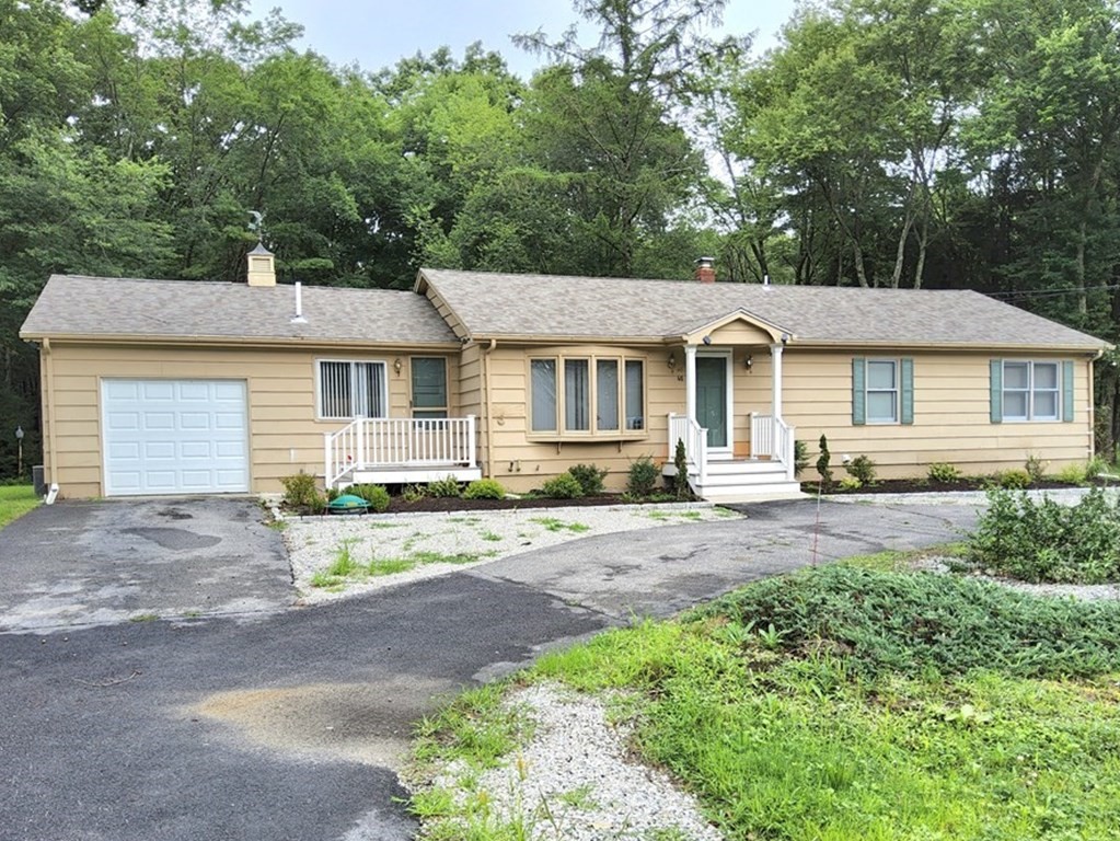 a front view of a house with a garden and patio