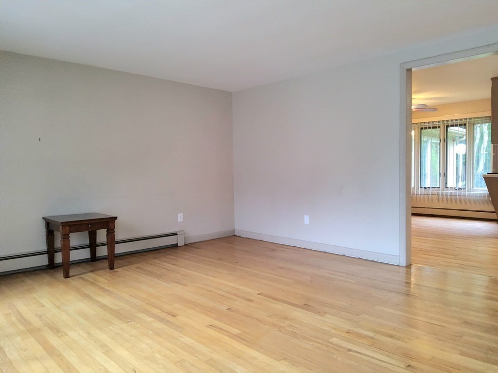 46 Lake Parkway Webster, MA 01570 - Photo 14 of 42 a view of an empty room with a window and wooden floor