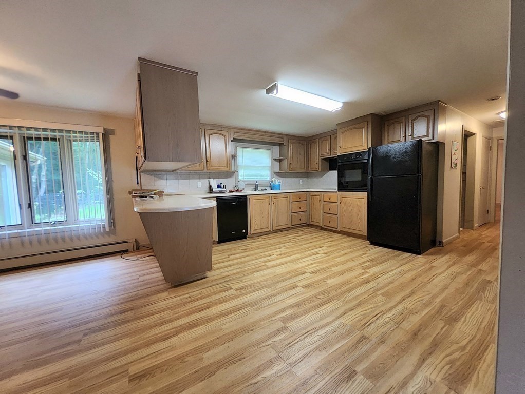 46 Lake Parkway Webster, MA 01570 - Photo 17 of 42 a large kitchen with stainless steel appliances granite countertop a large counter top and wooden floors