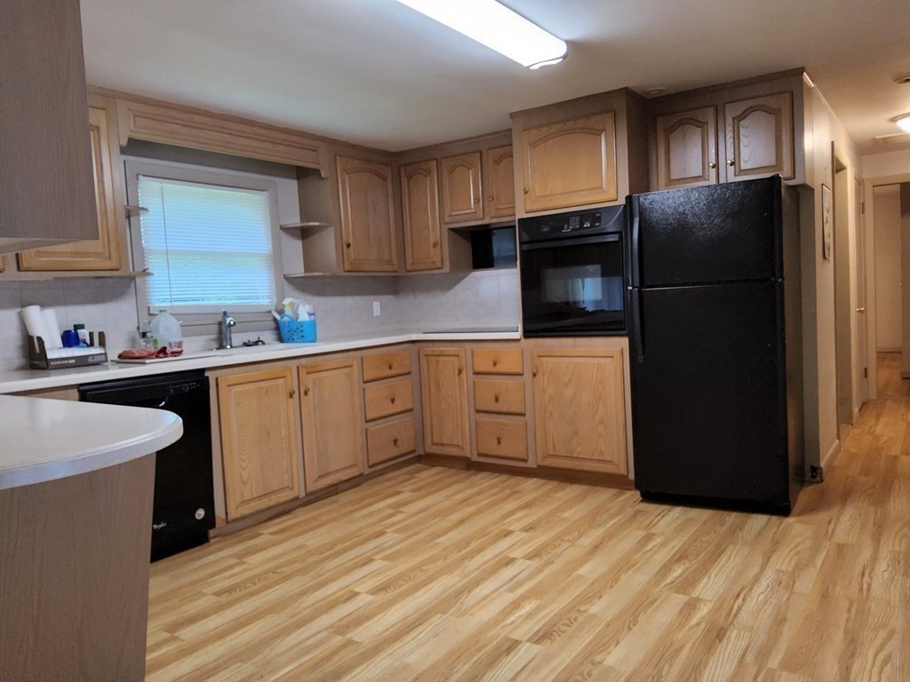 46 Lake Parkway Webster, MA 01570 - Photo 18 of 42 a kitchen with stainless steel appliances a refrigerator sink and cabinets