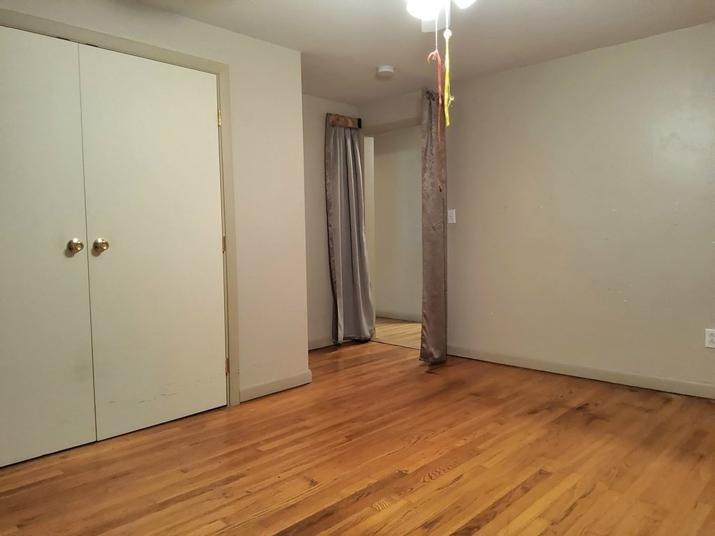 46 Lake Parkway Webster, MA 01570 - Photo 20 of 42 a view of a room with wooden floor and a ceiling fan