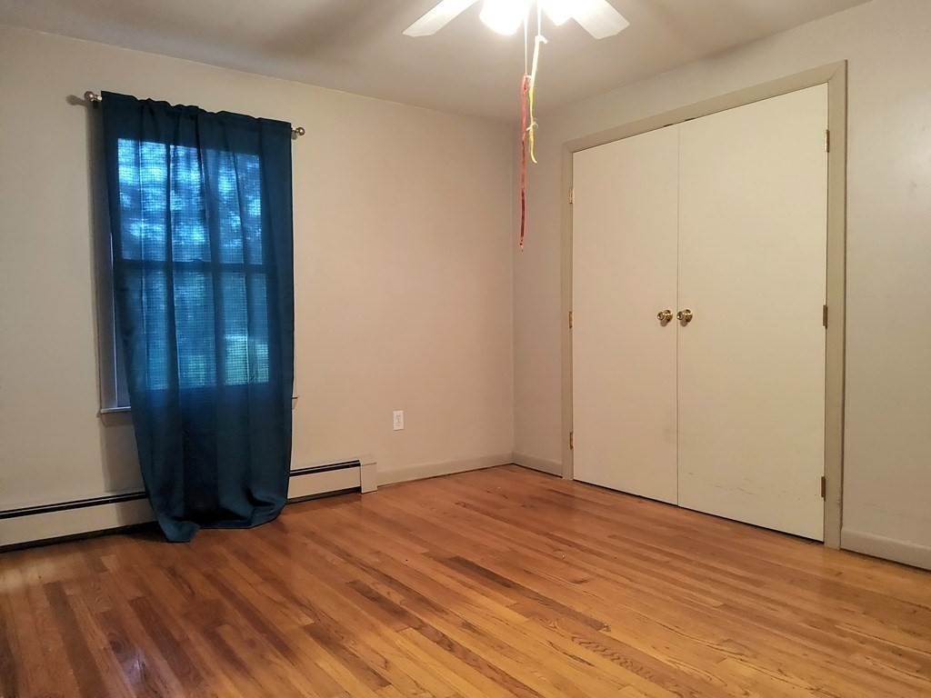 46 Lake Parkway Webster, MA 01570 - Photo 21 of 42 an empty room with wooden floor and closet
