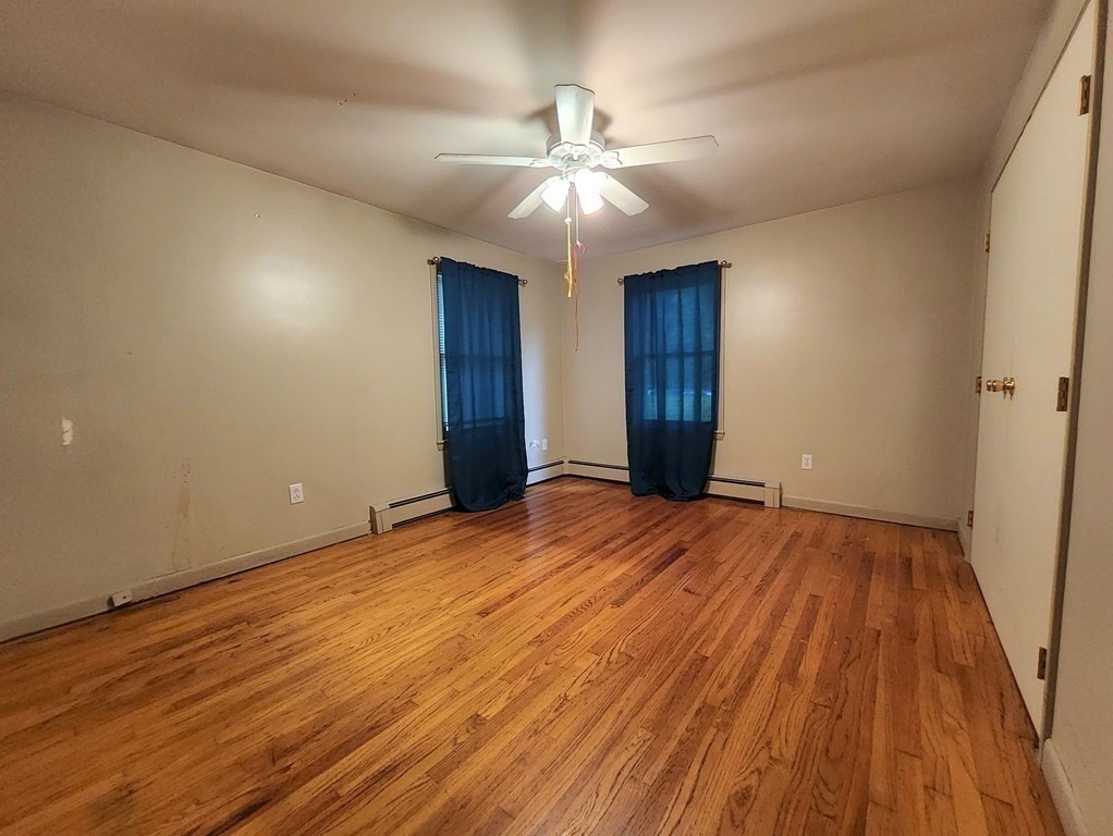 46 Lake Parkway Webster, MA 01570 - Photo 22 of 42 a view of an empty room with wooden floor