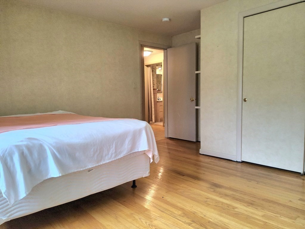 46 Lake Parkway Webster, MA 01570 - Photo 23 of 42 a bedroom with a bed and wooden floor