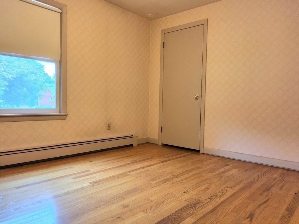 46 Lake Parkway Webster, MA 01570 - Photo 26 of 42 a view of an empty room with wooden floor and a window