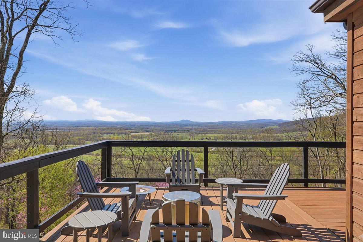 19897 Foresthill Road Bluemont, VA 20135 - Photo 8 of 39 a view of a balcony with chairs and wooden fence