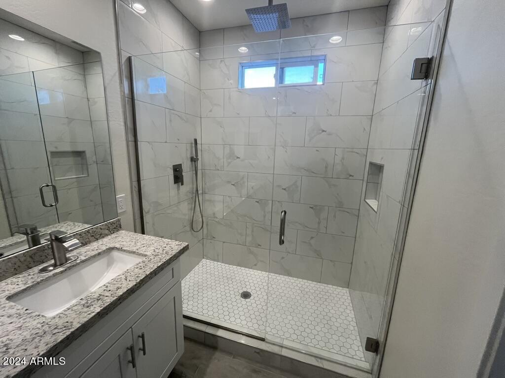 15200 South Diablo Road Arizona City, AZ 85123 - Photo 20 of 23 a bathroom with a granite countertop sink a toilet and shower