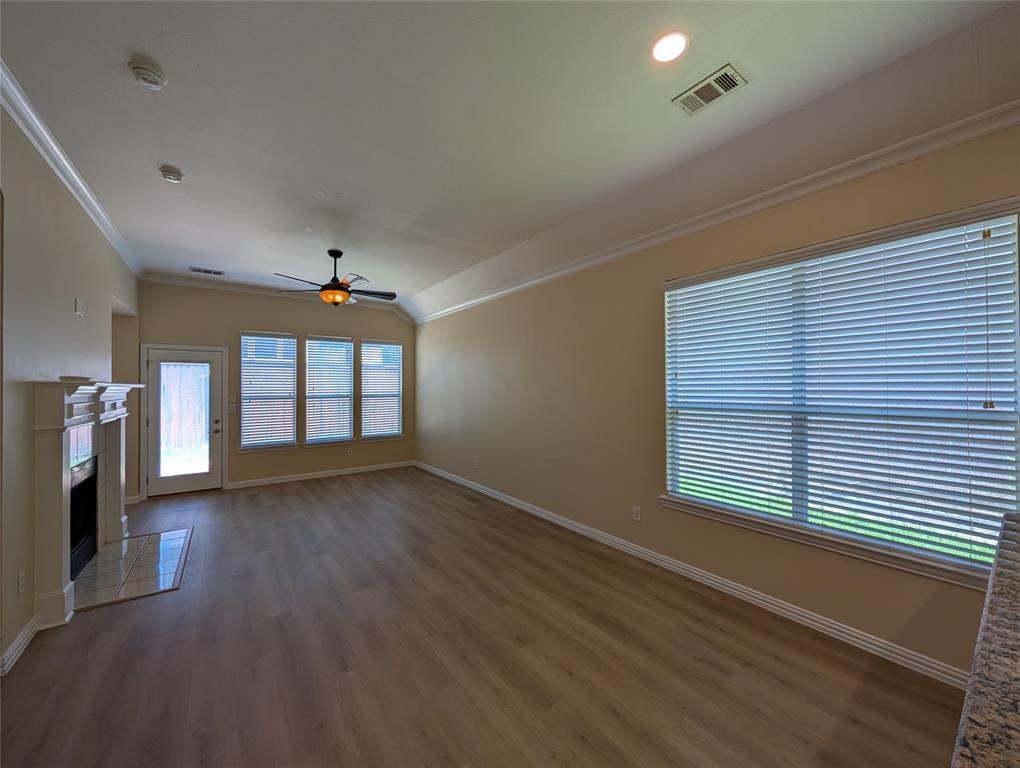 6620 Crator Drive McKinney, TX 75070 - Photo 12 of 26 a view of an empty room with a window and wooden floor
