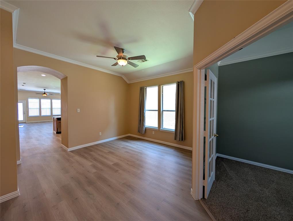 6620 Crator Drive McKinney, TX 75070 - Photo 3 of 26 a view of an empty room with window and wooden floor