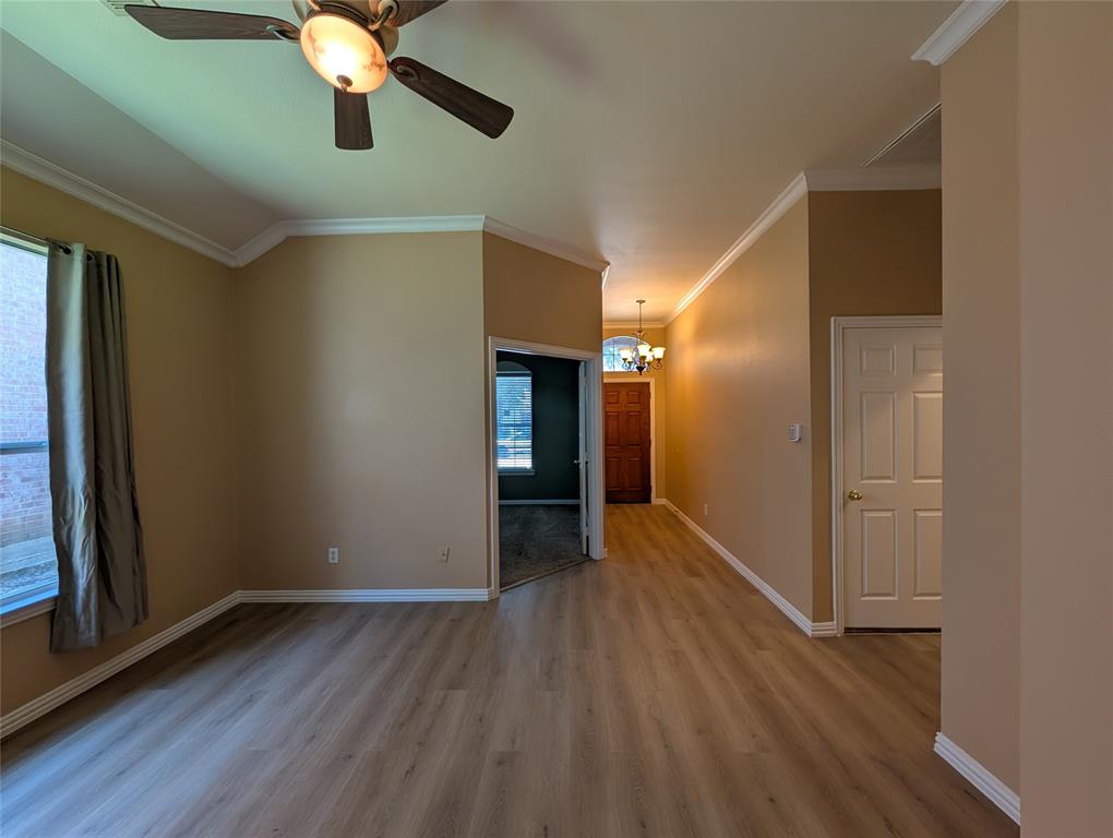 6620 Crator Drive McKinney, TX 75070 - Photo 5 of 26 a view of an empty room with wooden floor and a window