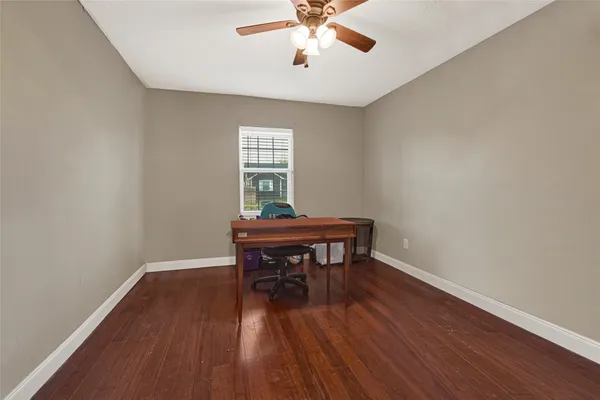 a view of a workspace with wooden floor