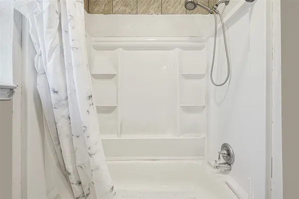 a bathroom with a glass shower door