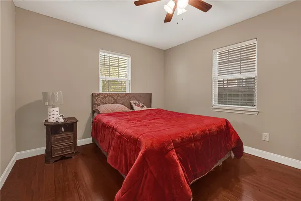 a bed sitting in a bedroom next to a window and a chandelier
