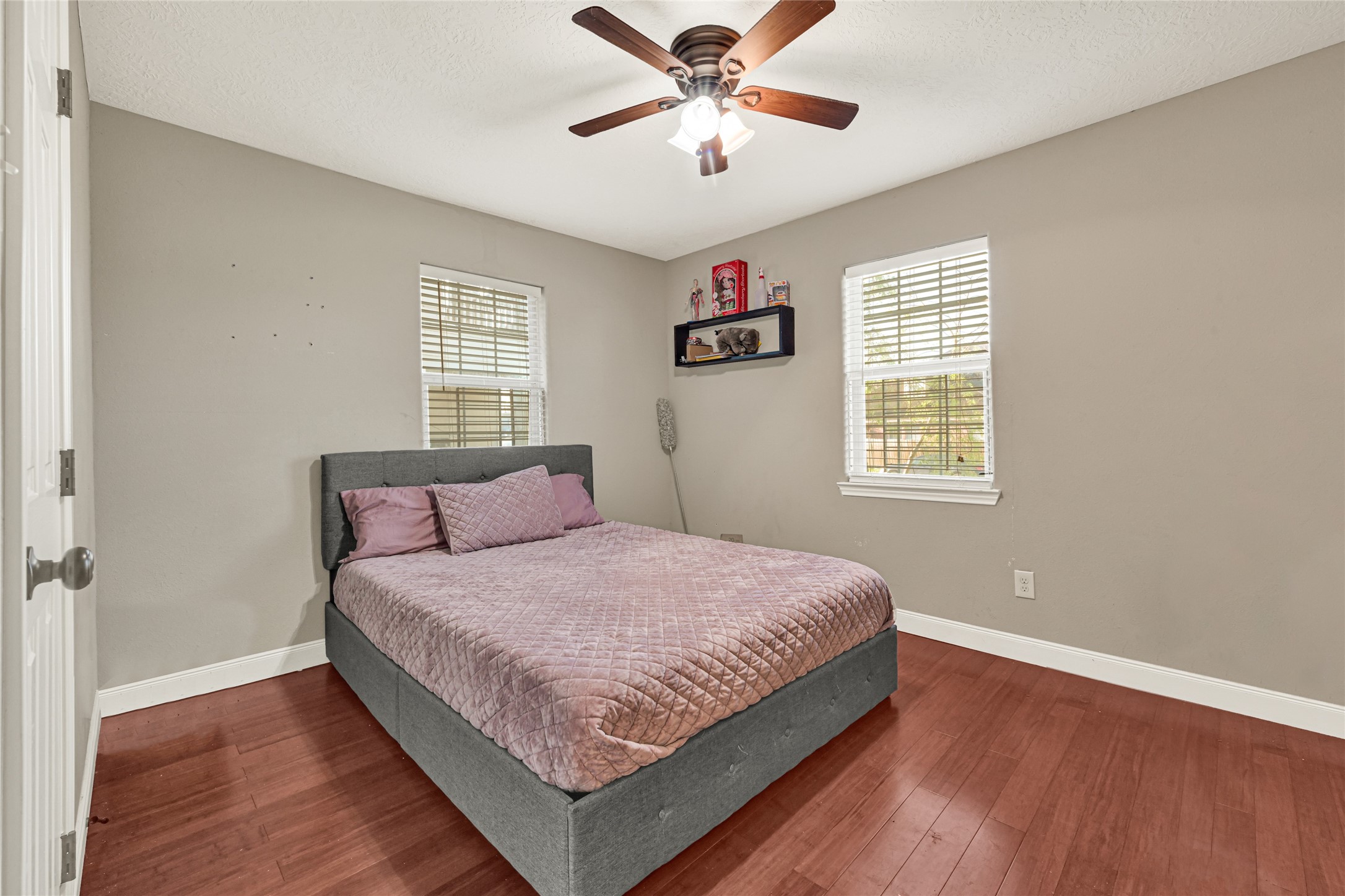 4529 Perry Street Houston, TX 77021 - Photo 15 of 20 a bedroom with a large bed chandelier and a window