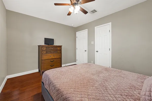 a bedroom with a bed and a ceiling fan