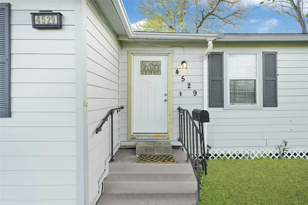 a view of front door of house with stairs