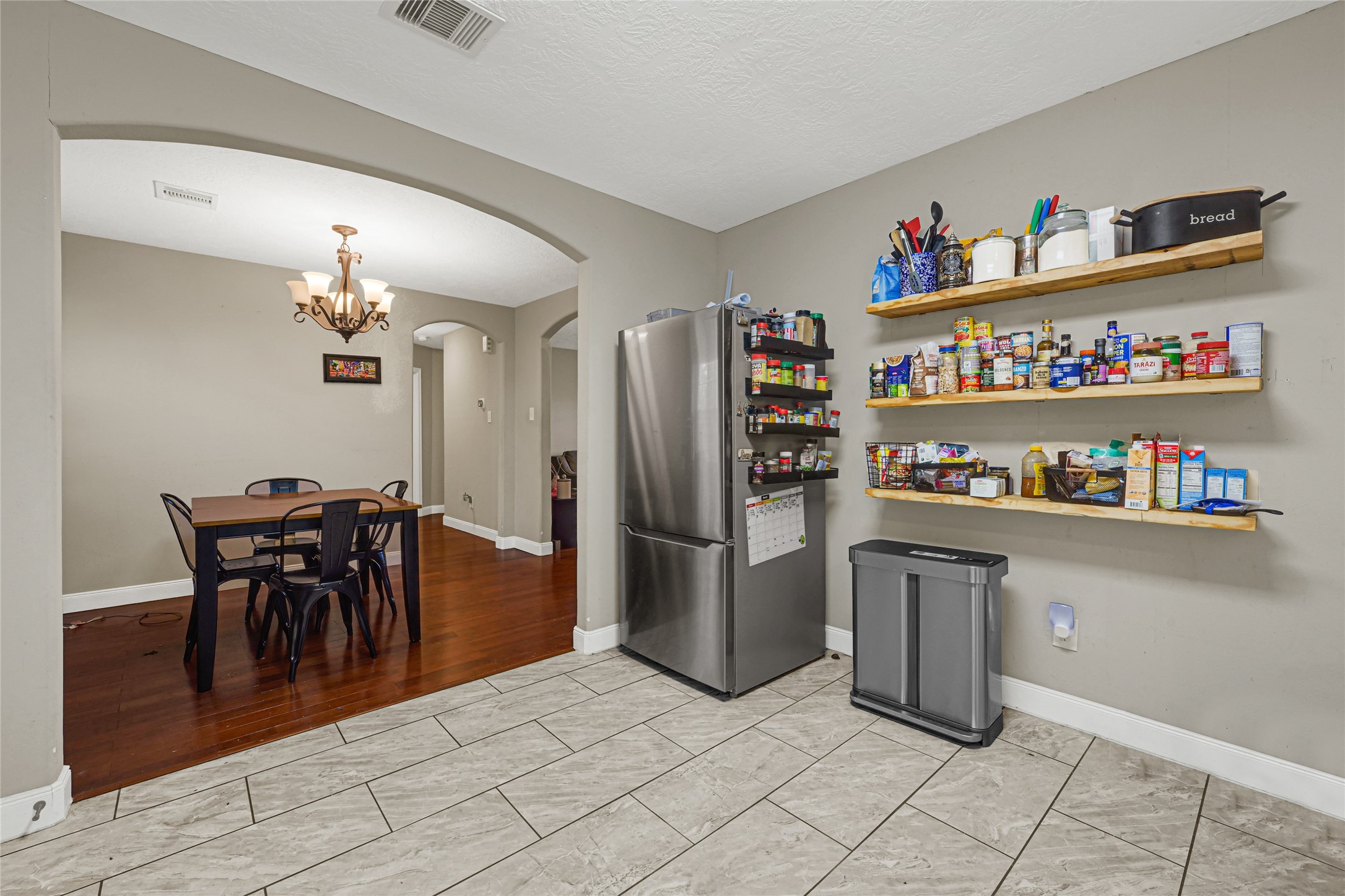 4529 Perry Street Houston, TX 77021 - Photo 6 of 20 a kitchen with granite countertop stainless steel appliances a refrigerator and a dining table